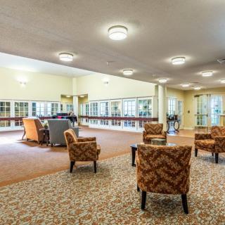 A spacious lobby area featuring comfortable seating and warm lighting.