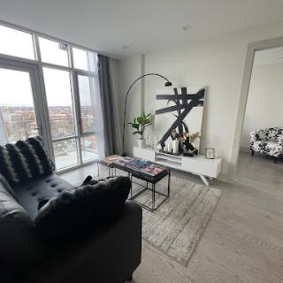 A stylish and modern living room featuring elegant furniture and ample natural light.
