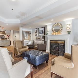 A cozy living room with comfortable seating and a warm fireplace.
