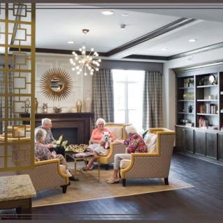 A group of seniors enjoying a conversation in a cozy living room.