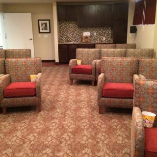 A well-organized waiting area with upholstered chairs and a decorative carpet.