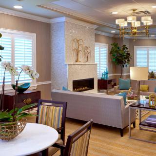 A modern living room with elegant decor, featuring a cozy fireplace and stylish furniture.