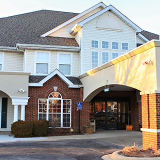 A residential building with a welcoming entrance and brick facade.