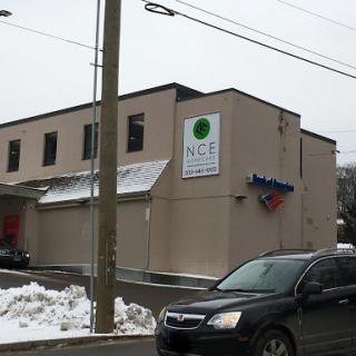 A building with signage partially covered in snow on a winter day.