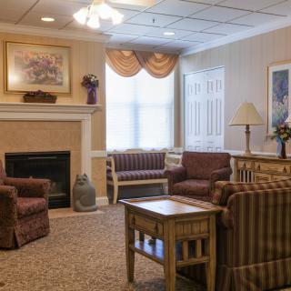 A cozy living room with comfortable seating and a fireplace.