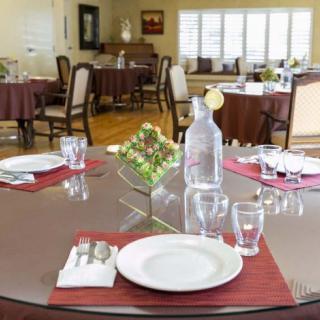 A neatly set dining table in a formal restaurant setting.