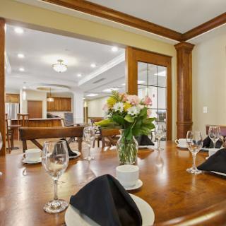 An elegant dining room setup featuring a beautifully arranged table with flowers, perfect for a special occasion.