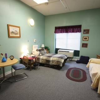 A cozy bedroom with two beds, decorated in a homey style.