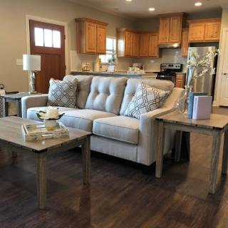 A cozy and modern living room setup featuring a comfortable sofa and stylish wooden furniture.