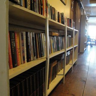A cozy library aisle filled with books on white shelves.