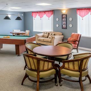 A cozy game room featuring a pool table and comfortable seating arrangements.