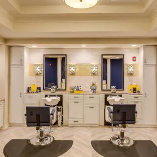 A modern barbershop interior with two styling stations and sleek design.