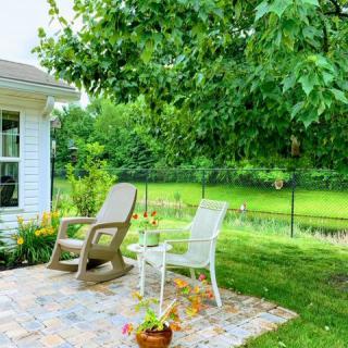 A peaceful patio setting with chairs overlooking a lush garden.