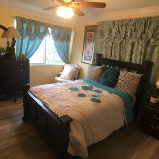 A cozy bedroom with elegant decor and a neatly made bed.