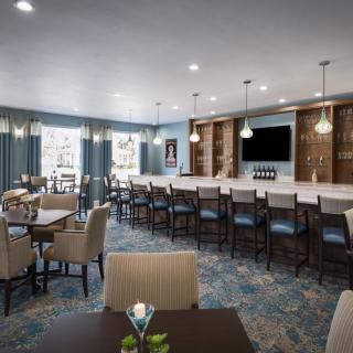 A modern bar and dining area with elegant seating and lighting.