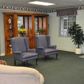 A cozy waiting room with chairs and decorative elements.
