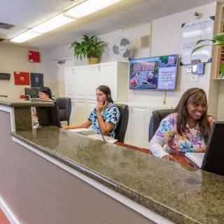 A busy reception area with employees assisting customers.