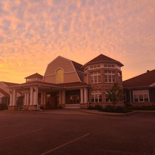 A beautiful residential building under a colorful sunset sky.