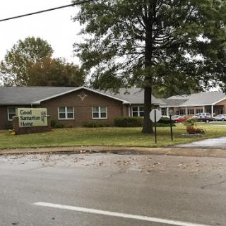 A community center building viewed from across the street on a rainy day.