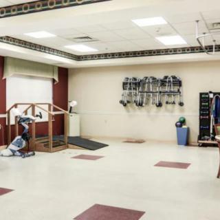 A well-equipped rehabilitation and physiotherapy room with exercise machines and other therapeutic tools.