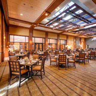 An elegant dining area featuring modern furnishings and warm lighting.