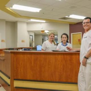 Medical staff at a hospital reception desk.