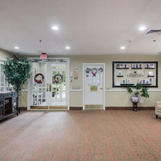 A well-lit lobby with decorative elements, including plants and seating arrangements.