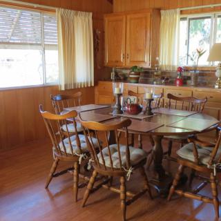 A cozy dining room with wooden furniture and soft lighting.