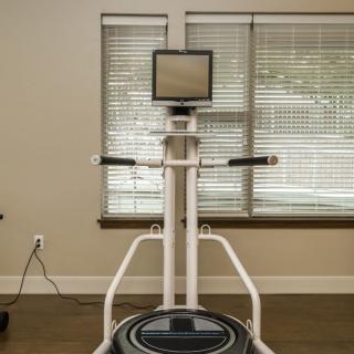 Modern gym equipment with a digital screen for interactive workouts.