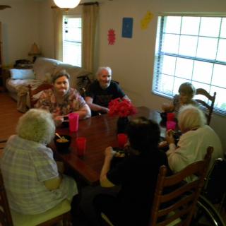 A group of seniors enjoying a meal together indoors.