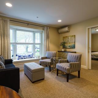 A cozy living room with comfortable seating and large windows allowing natural light.