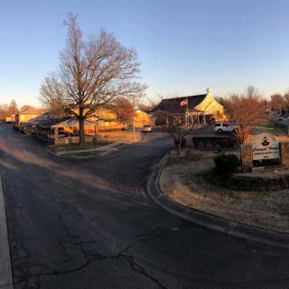 A suburban neighborhood with houses lining the street during sunset.