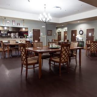 A cozy dining area with wooden tables and chairs arranged neatly.