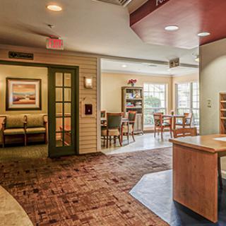 A cozy lobby with a reception desk and seating area.