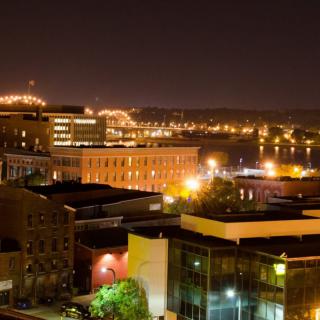 A cityscape illuminated by vibrant lights at night.