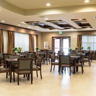 A spacious and well-lit dining area featuring modern furniture and a welcoming atmosphere.