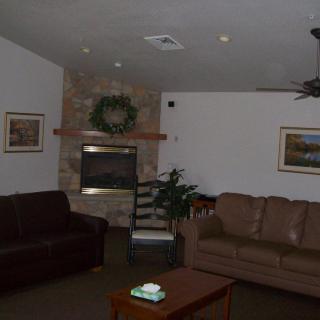 Cozy living room with sofas and a fireplace.