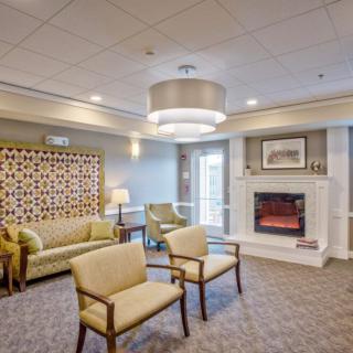 A cozy lounge area featuring comfortable seating and an elegant fireplace.