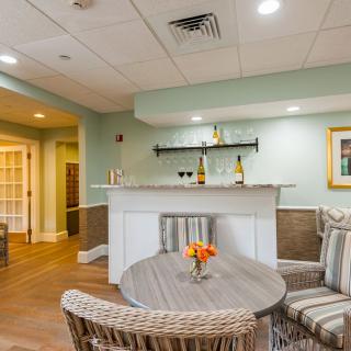 A cozy seating area with a small bar, featuring modern decor and inviting atmosphere.