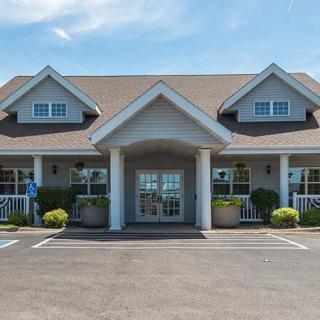 A suburban-style building with a welcoming entrance and surrounding landscaping.