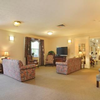 A spacious living room with comfortable seating and a television set.