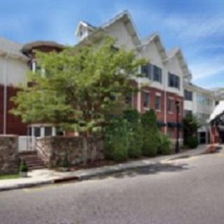 A charming residential building with greenery along the street.