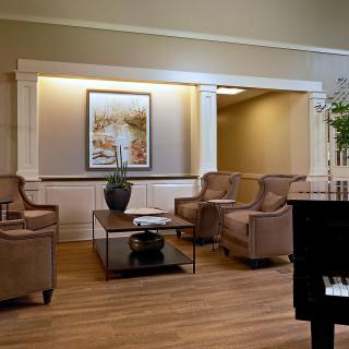 A cozy living room with comfortable chairs, a coffee table, and elegant decor.