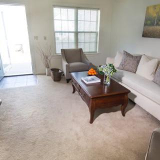 A cozy living room with a sofa, armchair, and coffee table.