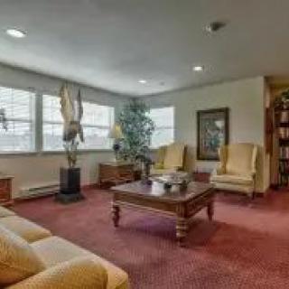 A cozy living room with comfortable seating and a warm carpet.
