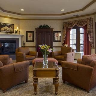 A cozy living room with comfortable seating, a fireplace, and elegant decor.