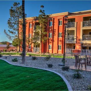 A well-maintained residential apartment complex with landscaped gardens.