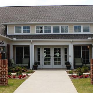 A modern residential house with a neatly landscaped front entrance.