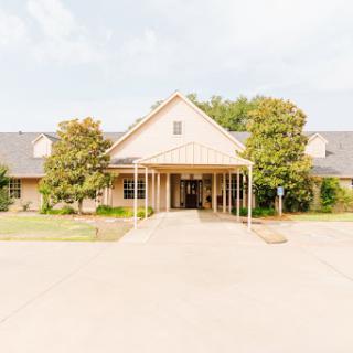 A welcoming entrance to a residential building surrounded by greenery.