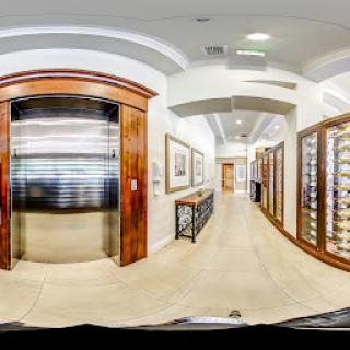 A spacious hallway featuring a sleek elevator and elegant wooden accents.